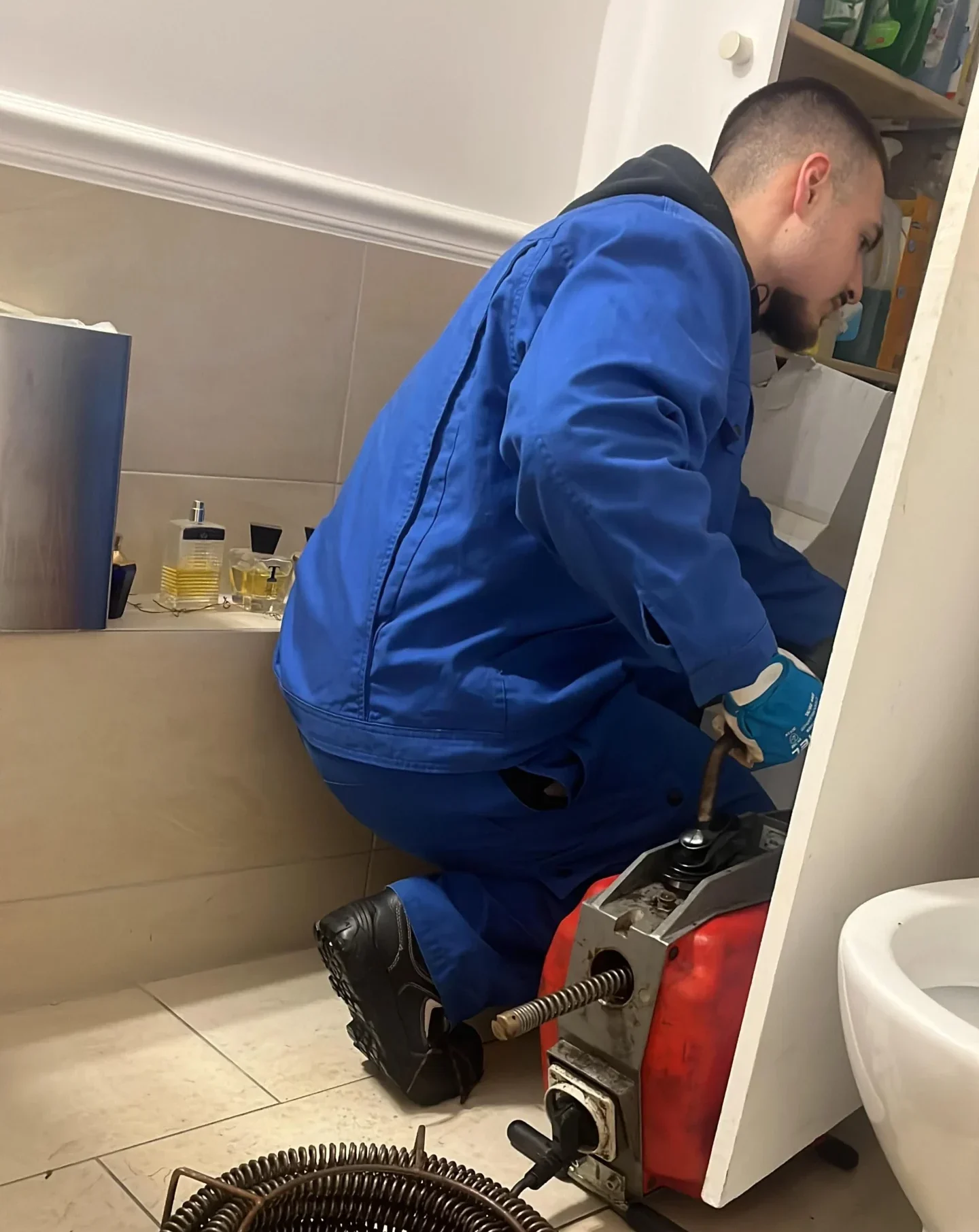 Plumber working with tools in a bathroom